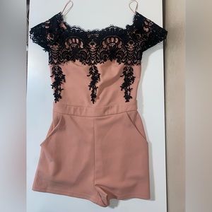 Pink romper with black lace detailing and pockets